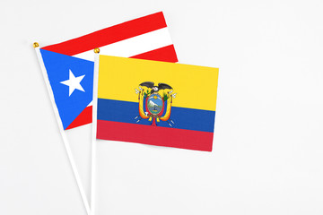Ecuador and Puerto Rico stick flags on white background. High quality fabric, miniature national flag. Peaceful global concept.White floor for copy space.