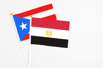 Egypt and Puerto Rico stick flags on white background. High quality fabric, miniature national flag. Peaceful global concept.White floor for copy space.