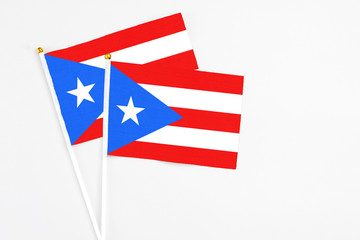 Puerto Rico and Puerto Rico stick flags on white background. High quality fabric, miniature national flag. Peaceful global concept.White floor for copy space.