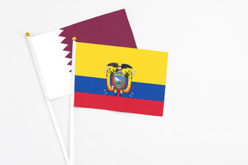 Ecuador and Qatar stick flags on white background. High quality fabric, miniature national flag. Peaceful global concept.White floor for copy space.