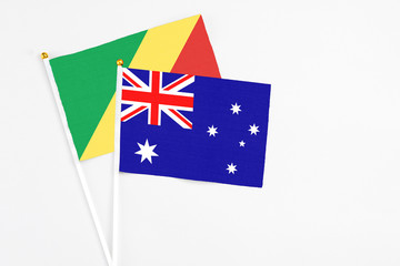 Fototapeta premium Australia and Republic Of The Congo stick flags on white background. High quality fabric, miniature national flag. Peaceful global concept.White floor for copy space.