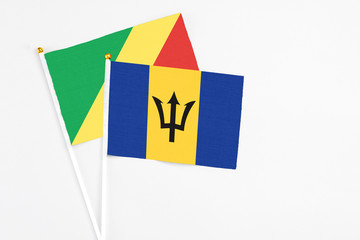 Barbados and Republic Of The Congo stick flags on white background. High quality fabric, miniature national flag. Peaceful global concept.White floor for copy space.