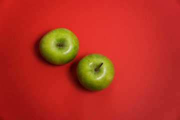 delicious green apple on a red background