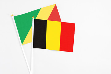 Belgium and Republic Of The Congo stick flags on white background. High quality fabric, miniature national flag. Peaceful global concept.White floor for copy space.