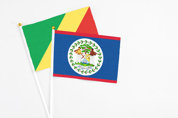 Belize and Republic Of The Congo stick flags on white background. High quality fabric, miniature national flag. Peaceful global concept.White floor for copy space.