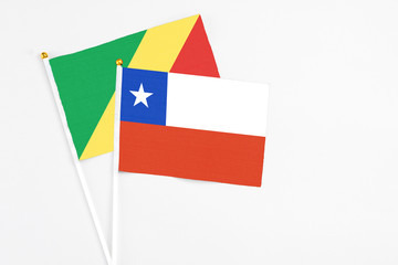 Chile and Republic Of The Congo stick flags on white background. High quality fabric, miniature national flag. Peaceful global concept.White floor for copy space.