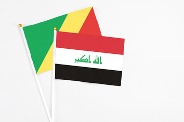 Iraq and Republic Of The Congo stick flags on white background. High quality fabric, miniature national flag. Peaceful global concept.White floor for copy space.