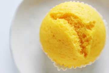 yellow steamed bun on dish for lemon cake image