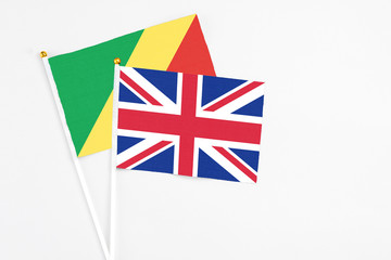 United Kingdom and Republic Of The Congo stick flags on white background. High quality fabric, miniature national flag. Peaceful global concept.White floor for copy space.