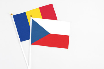Czech Republic and Romania stick flags on white background. High quality fabric, miniature national flag. Peaceful global concept.White floor for copy space.