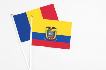 Ecuador and Romania stick flags on white background. High quality fabric, miniature national flag. Peaceful global concept.White floor for copy space.