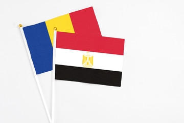Egypt and Romania stick flags on white background. High quality fabric, miniature national flag. Peaceful global concept.White floor for copy space.