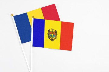 Moldova and Romania stick flags on white background. High quality fabric, miniature national flag. Peaceful global concept.White floor for copy space.