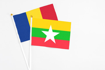 Myanmar and Romania stick flags on white background. High quality fabric, miniature national flag. Peaceful global concept.White floor for copy space.