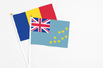 Tuvalu and Romania stick flags on white background. High quality fabric, miniature national flag. Peaceful global concept.White floor for copy space.