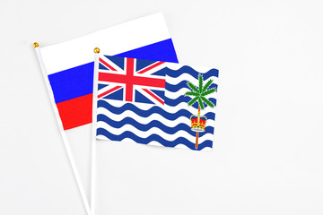 Fototapeta premium British Indian Ocean Territory and Russia stick flags on white background. High quality fabric, miniature national flag. Peaceful global concept.White floor for copy space.