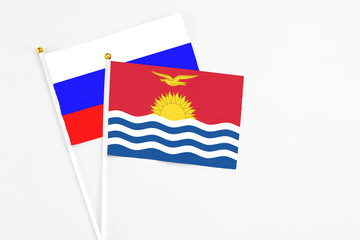 Kiribati and Russia stick flags on white background. High quality fabric, miniature national flag. Peaceful global concept.White floor for copy space.