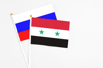 Syria and Russia stick flags on white background. High quality fabric, miniature national flag....