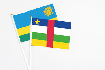 Central African Republic and Rwanda stick flags on white background. High quality fabric, miniature national flag. Peaceful global concept.White floor for copy space.