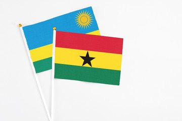 Ghana and Rwanda stick flags on white background. High quality fabric, miniature national flag. Peaceful global concept.White floor for copy space.
