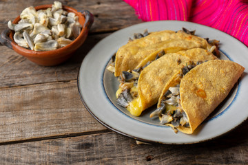 Mexican corn smut quesadilla  also called "huitlacoche" on wooden background