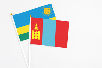 Mongolia and Rwanda stick flags on white background. High quality fabric, miniature national flag. Peaceful global concept.White floor for copy space.