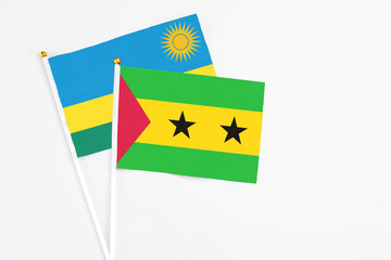 Sao Tome And Principe and Rwanda stick flags on white background. High quality fabric, miniature national flag. Peaceful global concept.White floor for copy space.