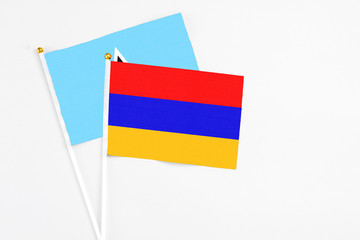 Armenia and Saint Lucia stick flags on white background. High quality fabric, miniature national flag. Peaceful global concept.White floor for copy space.