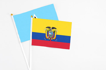 Ecuador and Saint Lucia stick flags on white background. High quality fabric, miniature national flag. Peaceful global concept.White floor for copy space.