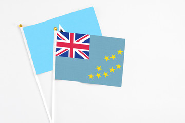 Fototapeta premium Tuvalu and Saint Lucia stick flags on white background. High quality fabric, miniature national flag. Peaceful global concept.White floor for copy space.