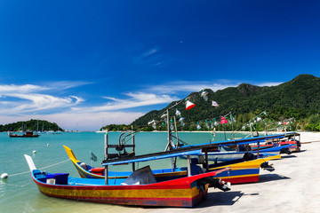 Telaga Harbor beach with colourful squid fishing boats on Langkawi island, also known as Pulau Langkawi, Andaman Sea, State of Kedah, Malaysia. - obrazy, fototapety, plakaty