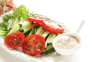 Homemade cucumber and tomato salad served with sesame seed