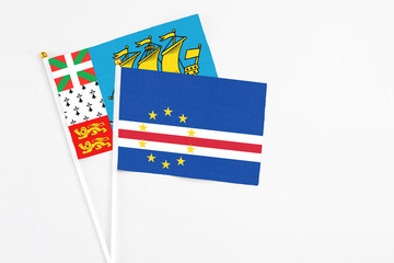 Cape Verde and Saint Pierre And Miquelon stick flags on white background. High quality fabric, miniature national flag. Peaceful global concept.White floor for copy space.
