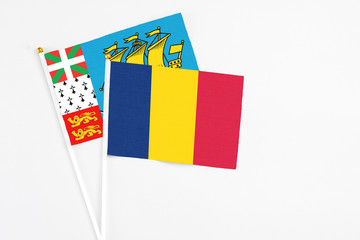 Chad and Saint Pierre And Miquelon stick flags on white background. High quality fabric, miniature national flag. Peaceful global concept.White floor for copy space.