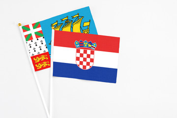 Croatia and Saint Pierre And Miquelon stick flags on white background. High quality fabric, miniature national flag. Peaceful global concept.White floor for copy space.