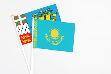 Kazakhstan and Saint Pierre And Miquelon stick flags on white background. High quality fabric, miniature national flag. Peaceful global concept.White floor for copy space.