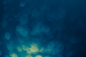 dark blue Festive Christmas Beautiful abstract Background with bokeh lights. Holiday Texture with copy space. Can be used as Wallpaper, filling for a website, defocused