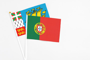 Portugal and Saint Pierre And Miquelon stick flags on white background. High quality fabric, miniature national flag. Peaceful global concept.White floor for copy space.