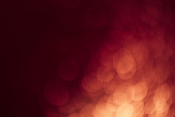 Red gold Festive Christmas Beautiful abstract Background with bokeh lights. Holiday Texture with copy space. Can be used as Wallpaper, filling for a website, defocused