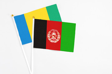 Afghanistan and Saint Vincent And The Grenadines stick flags on white background. High quality fabric, miniature national flag. Peaceful global concept.White floor for copy space.