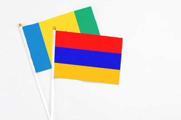 Armenia and Saint Vincent And The Grenadines stick flags on white background. High quality fabric,...