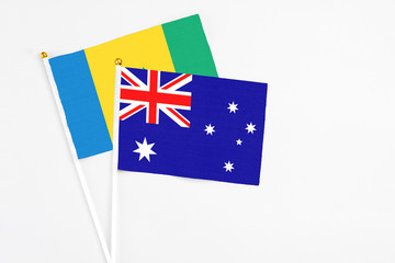 Fototapeta premium Australia and Saint Vincent And The Grenadines stick flags on white background. High quality fabric, miniature national flag. Peaceful global concept.White floor for copy space.