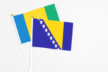 Bosnia Herzegovina and Saint Vincent And The Grenadines stick flags on white background. High...