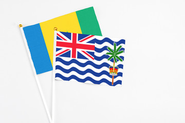 Fototapeta premium British Indian Ocean Territory and Saint Vincent And The Grenadines stick flags on white background. High quality fabric, miniature national flag. Peaceful global concept.White floor for copy space.