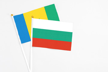 Bulgaria and Saint Vincent And The Grenadines stick flags on white background. High quality fabric, miniature national flag. Peaceful global concept.White floor for copy space.