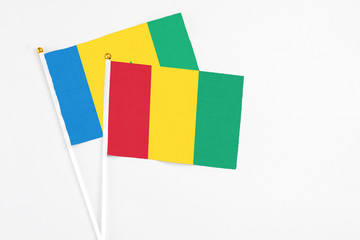 Guinea and Saint Vincent And The Grenadines stick flags on white background. High quality fabric,...