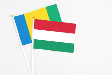 Hungary and Saint Vincent And The Grenadines stick flags on white background. High quality fabric, miniature national flag. Peaceful global concept.White floor for copy space.
