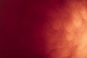 Red gold Festive Christmas Beautiful abstract Background with bokeh lights. Holiday Texture with copy space. Can be used as Wallpaper, filling for a website, defocused