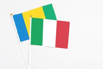 Italy and Saint Vincent And The Grenadines stick flags on white background. High quality fabric, miniature national flag. Peaceful global concept.White floor for copy space.