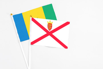 Jersey and Saint Vincent And The Grenadines stick flags on white background. High quality fabric,...